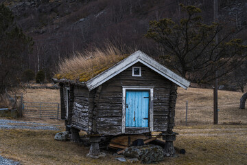 Little Scandinavian hut with moss on roof