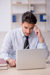 Young male employee working in the office