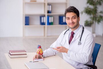 Young male doctor cardiologist working in the clinic