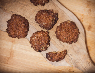 homemade Cereal cookies or protein biscuits on wooden cutting board .rustic healthy eating .