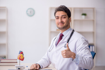 Young male doctor cardiologist working in the clinic