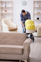 Young man looking after newborn at home
