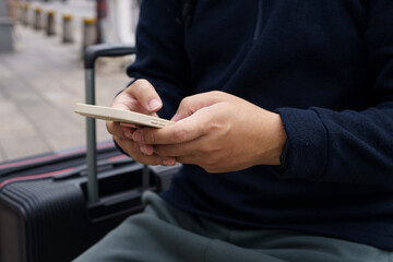 Man in downtown city street ordering taxi using smart phone app Booking taxi using application online on smart phone