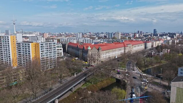Drone shot of two trains crossing near a Historic Government building , Kreuzberg , Berlin , Germany
