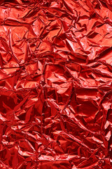 red shiny crinkle aluminum foil as background
