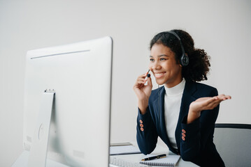Serious call center operator in wireless headset talking with customer, woman in headphones with microphone consulting client on phone in customer support service in office