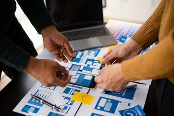 UI designer and UX developer team designer brainstorming about mobile app interface wireframe...