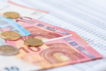 Business finance and accounting background with euro and dollar money on data sheet.