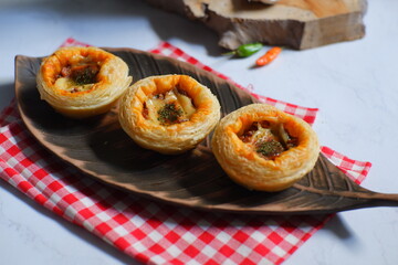 Baked puff pastry with sauce and cheese