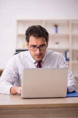Fototapeta premium Young male employee and too much work in the office