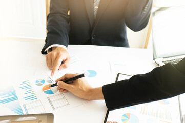 Businessman analyzing investment charts and pressing calculator buttons over documents. Accounting Concept.