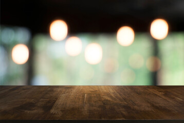 Empty wooden table in front of abstract blurred background of coffee shop . can be used for display Mock up  of product