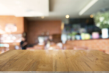 Empty wooden table in front of abstract blurred background of coffee shop . can be used for display Mock up  of product