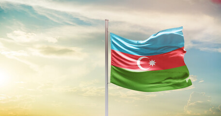 Azerbaijan national flag waving in beautiful sky. The symbol of the state on wavy silk fabric.