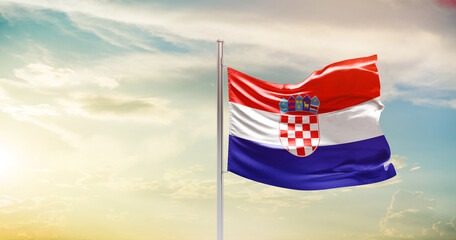 Croatia national flag waving in beautiful sky. The symbol of the state on wavy silk fabric.