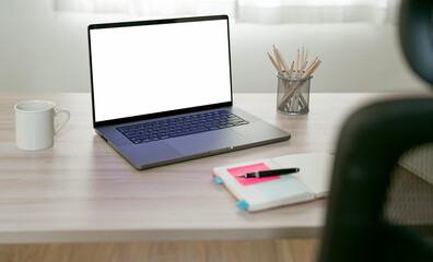 Mock up white blank screen laptop computer on wooden table, creative workspace with open laptop computer, home office.