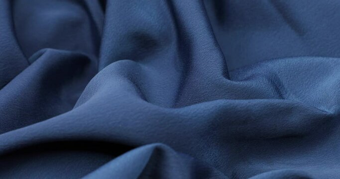 Blue fabric background. Blue cloth waves background texture. Blue fabric cloth textile material.
