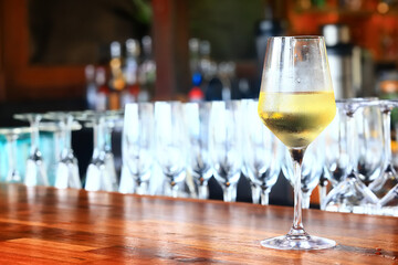 a glass of white wine in a restaurant, alcohol luxury background
