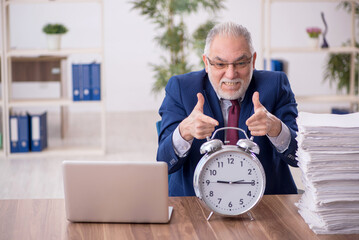 Old male employee in time management concept