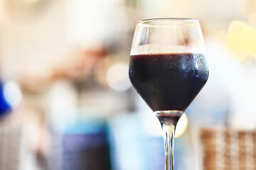 a glass of red wine in a luxurious background restaurant