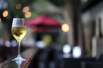 a glass of white wine in a restaurant, alcohol luxury background