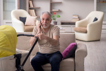 Old man looking after newborn at home