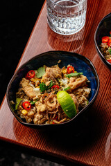 fried Chinese rice with chicken, vegetables and herbs. restauran