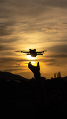 Naklejka na ściany i meble silhouette of a drone at sunset