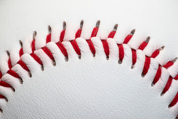 Texture of a white baseball with a red seam