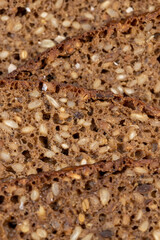 Black rye bread cut into chunks with sunflower seeds