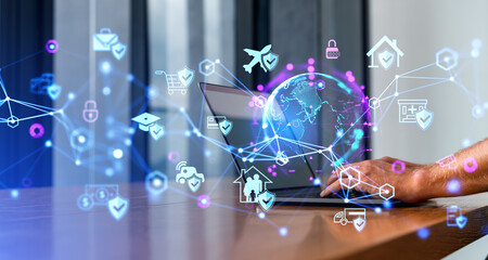 Businessman hands with laptop, earth sphere and diverse digital icons