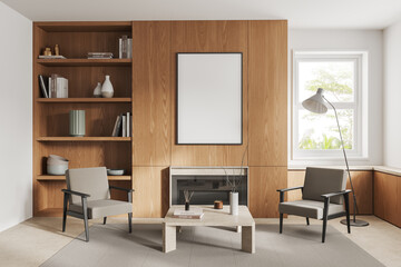 White and wooden living room with fireplace, armchairs and poster