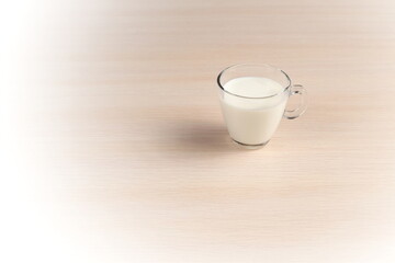 A Glass Of Fresh Milk on a Wooden Tabletop. Diet Conception. Copy Space. Light Vignette