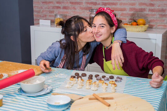 Mother And Daughter baking a homemade traditinal pastry