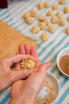 Hands working with dough and decorating pastry