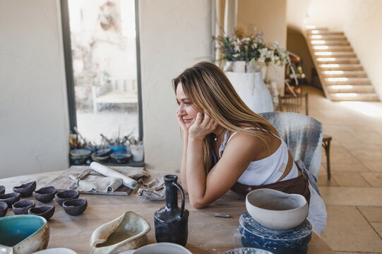 portrait of a ceramist girl sitting at a table