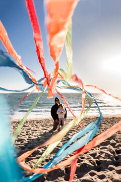 Dad and Daughter Flying Kite At Beach