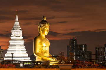 View of seated buddha in Wat Paknam Phasi Charoen temple at sunset