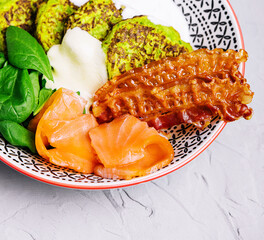 pumpkin pancakes with fried bacon and salmon