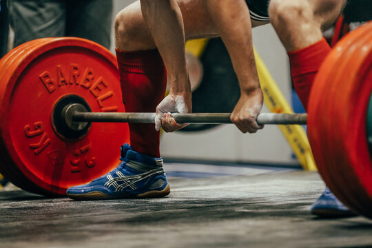 body part and barbells male powerlifter deadlift in powerlifting. Asics deadlift boots in legs