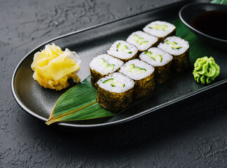 Kappamaki - cucumber sushi roll on black plate