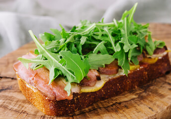 Bacon and egg sandwich with provolone cheese and arugula