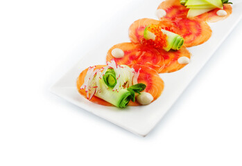 Smoked salmon fillet sliced and decorated with red caviar with zucchini