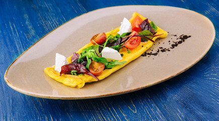Omelette with cherry tomatoes and goat cheese