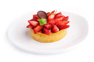 Tartlet with strawberry on white plate