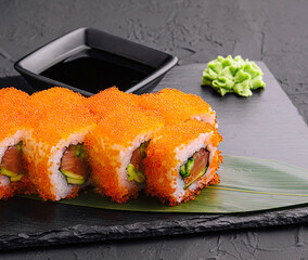 Sushi rolls philadelphia on a black slate