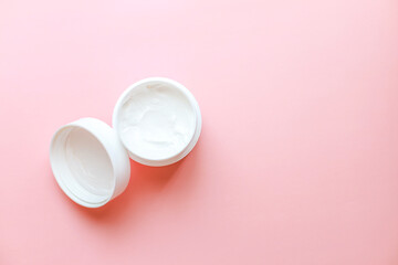 .Top view laying out hand cream on pink background