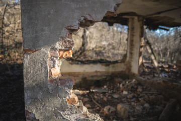 Fototapeta premium old ruined house, not suitable for living, fallen brick wall