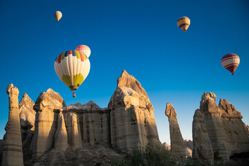 Fototapeta na wymiar beautiful scenery flight of balloons in the mountains of Cappadocia in love valley