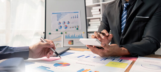 A group of business people working together on a new project to analyze budgets and manage investment risks in today's profit boosting for marketing in the conference room.